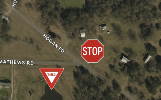 Place STOP Sign at the Intersection of Matthews & Hogan Road